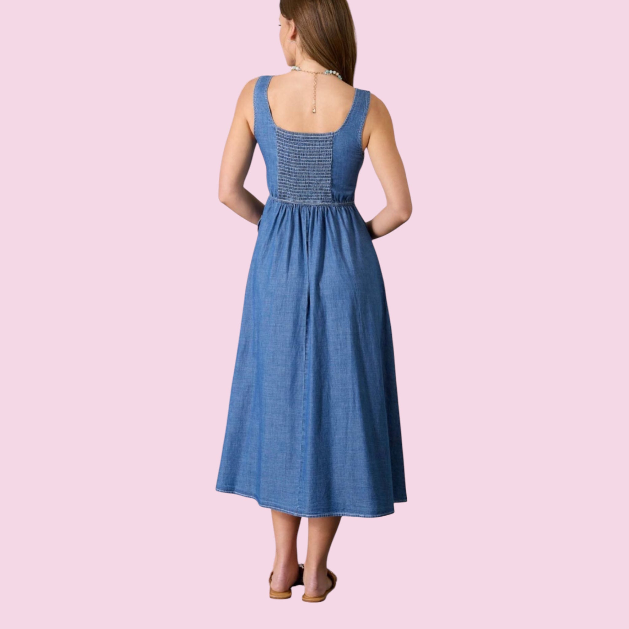 Woman wearing a blue dress on a pink background