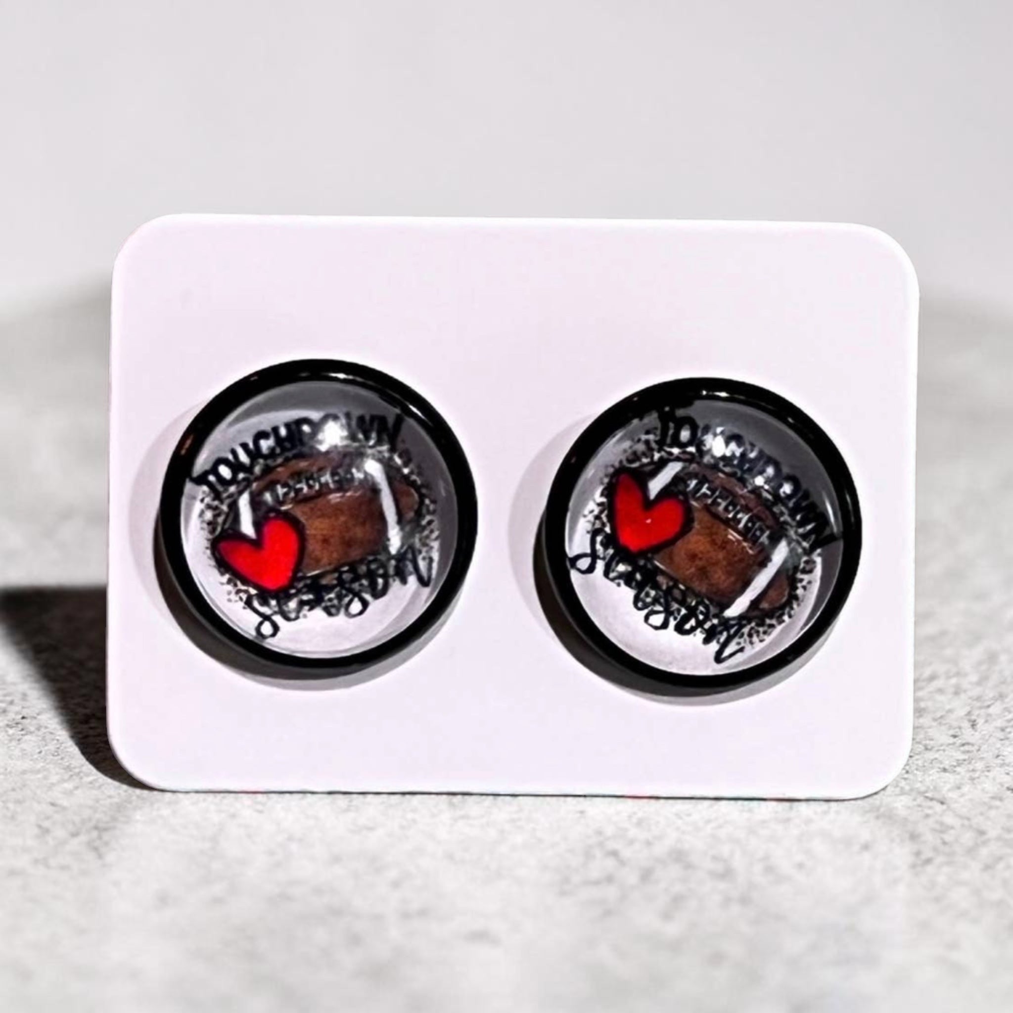 Pair of earrings with a heart design on a white card