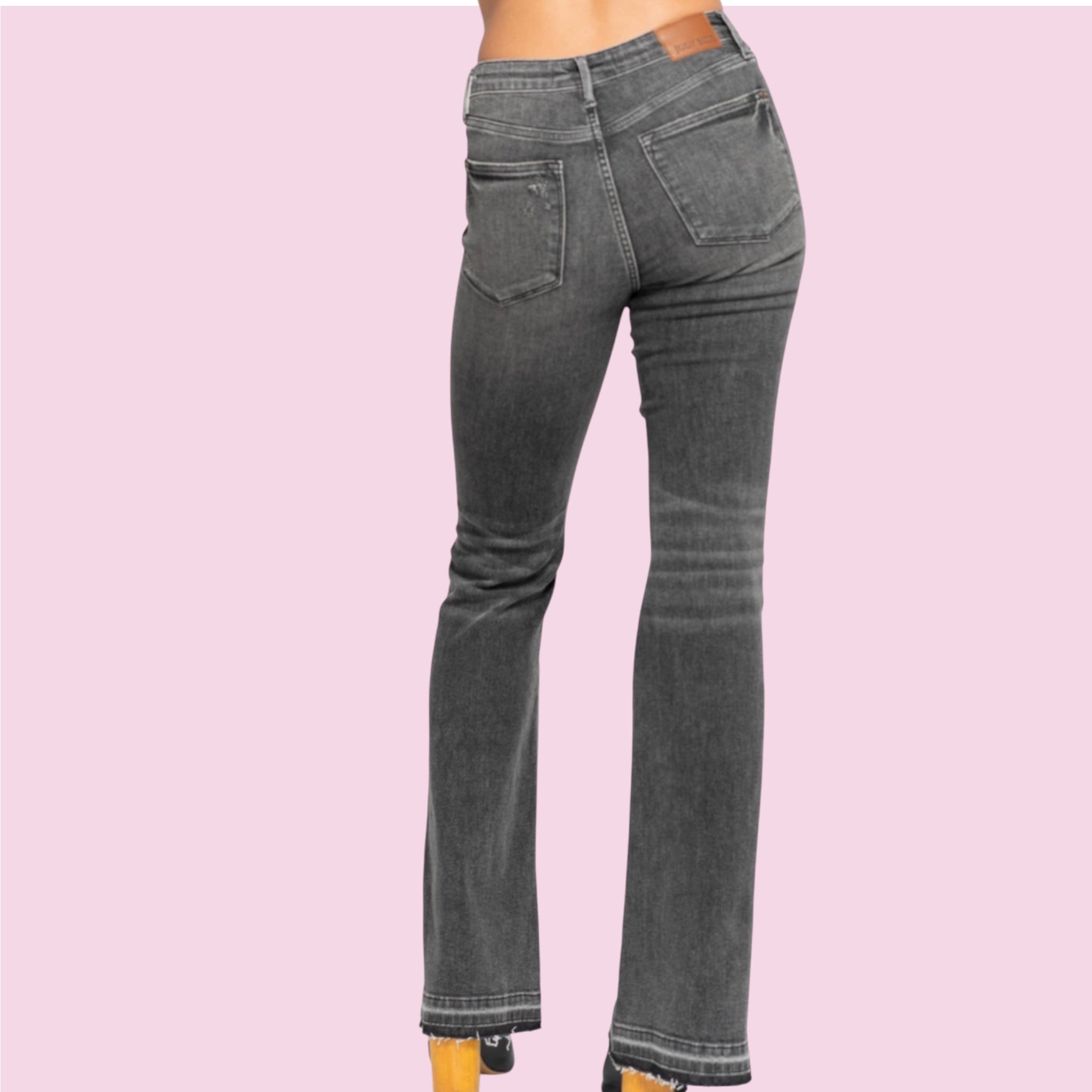 Gray jeans on a pink background