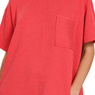 Red textured shirt with a pocket on a white background