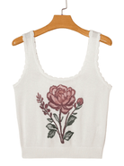 White tank top with a floral design on a beige background