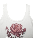 White tank top with a pink rose design on a light gray background
