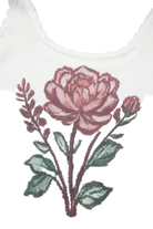 Embroidered flower design on a white fabric background