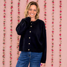 Woman wearing the Vintage Soul raw edge button-front cardigan in navy with jeans
