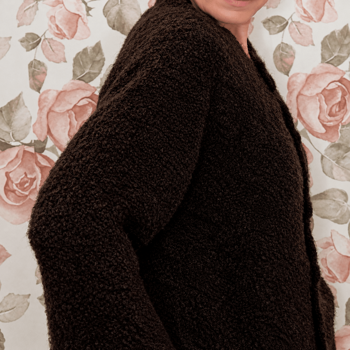 Close-up side view of chocolate brown cardigan showing the soft, nubby boucle knit texture