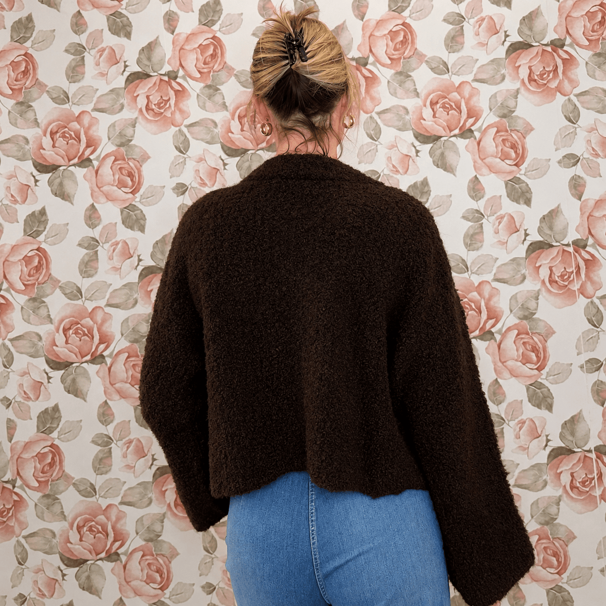 Back view of chocolate brown fuzzy knit cardigan showing the cropped, boxy fit and wide sleeves