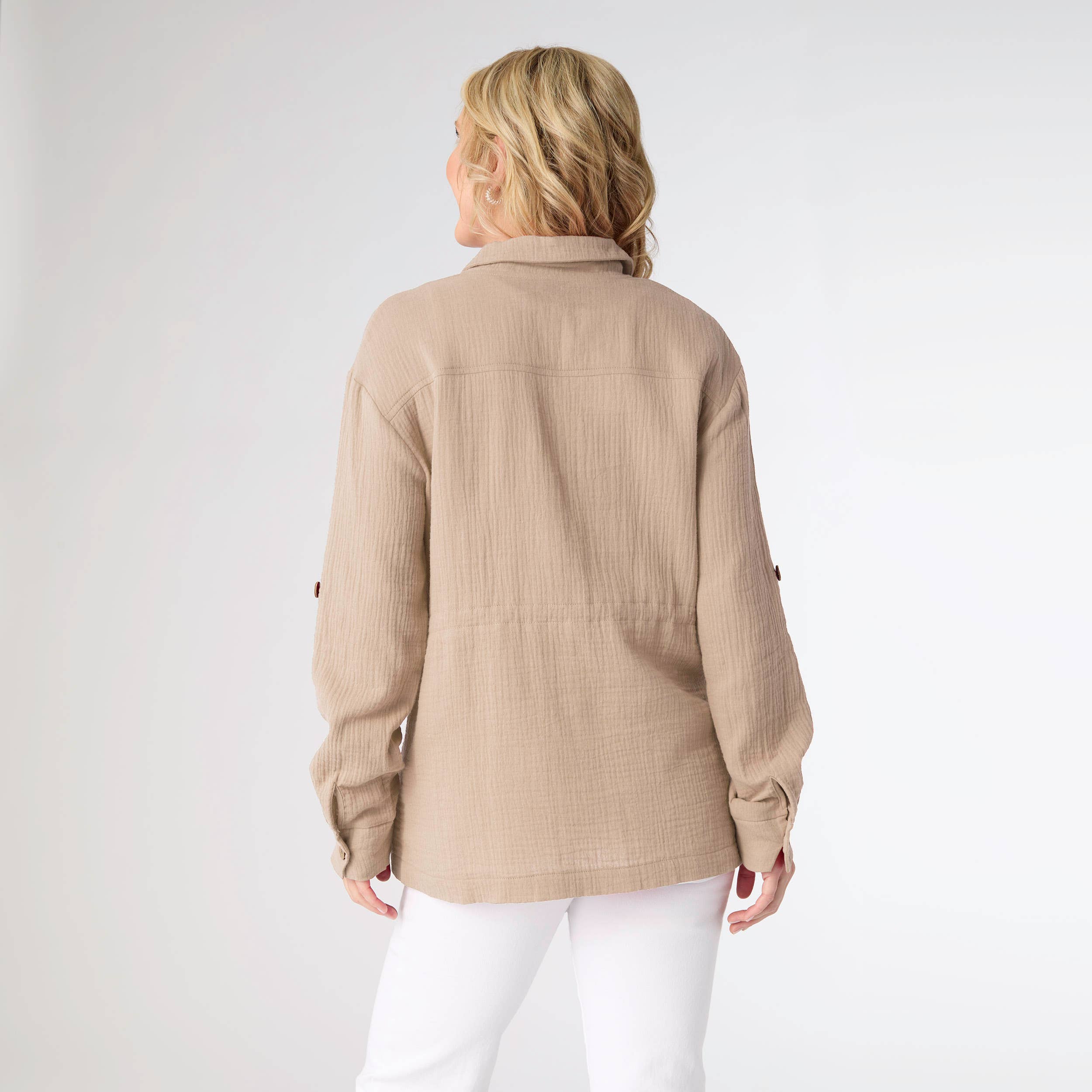 Woman wearing a beige jacket on a white background