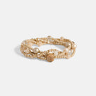 Multistrand beaded bracelet with pearls on a light gray background