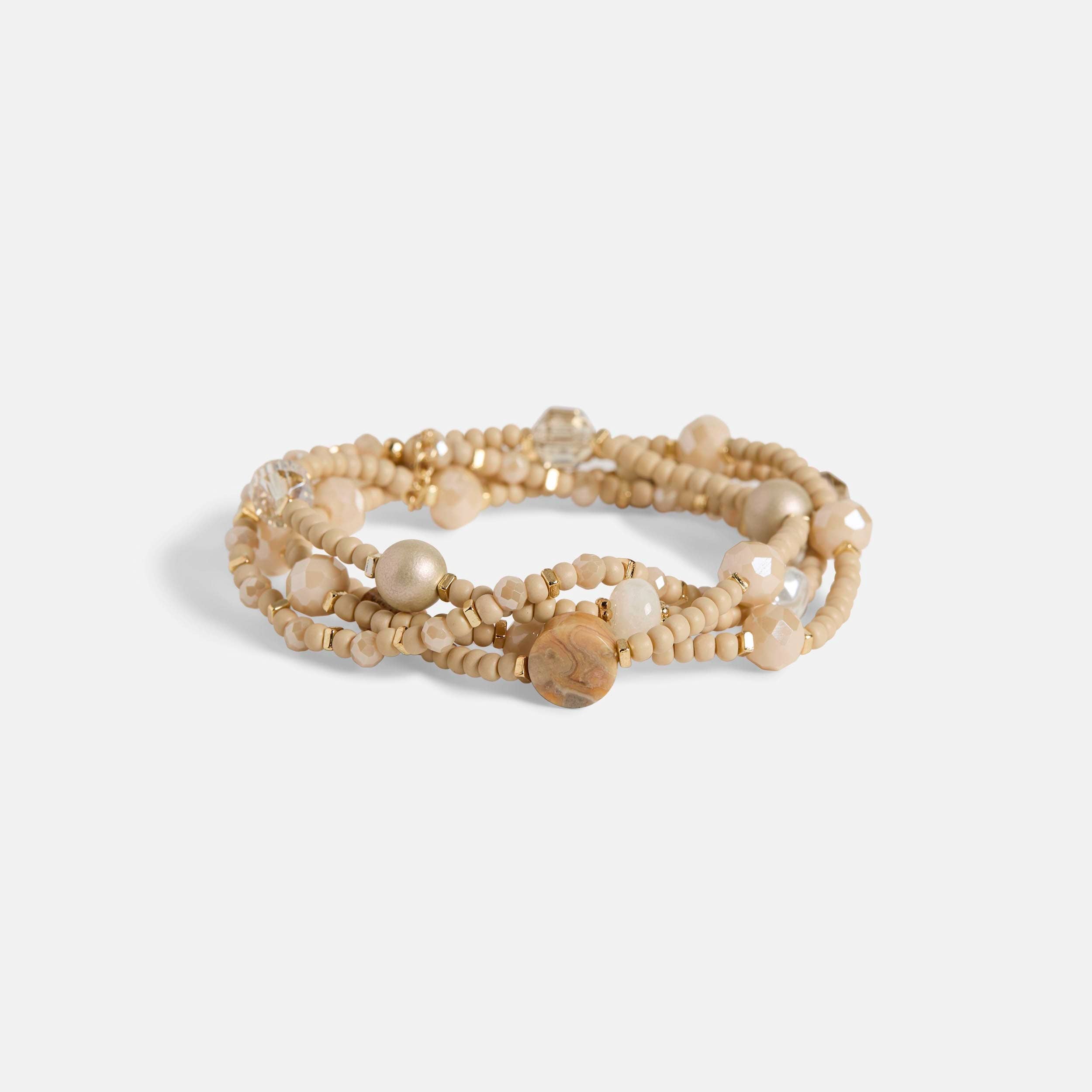 Multistrand beaded bracelet with pearls on a light gray background