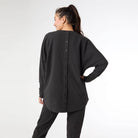 Back view of the black brushed sweater showing the button-back detail