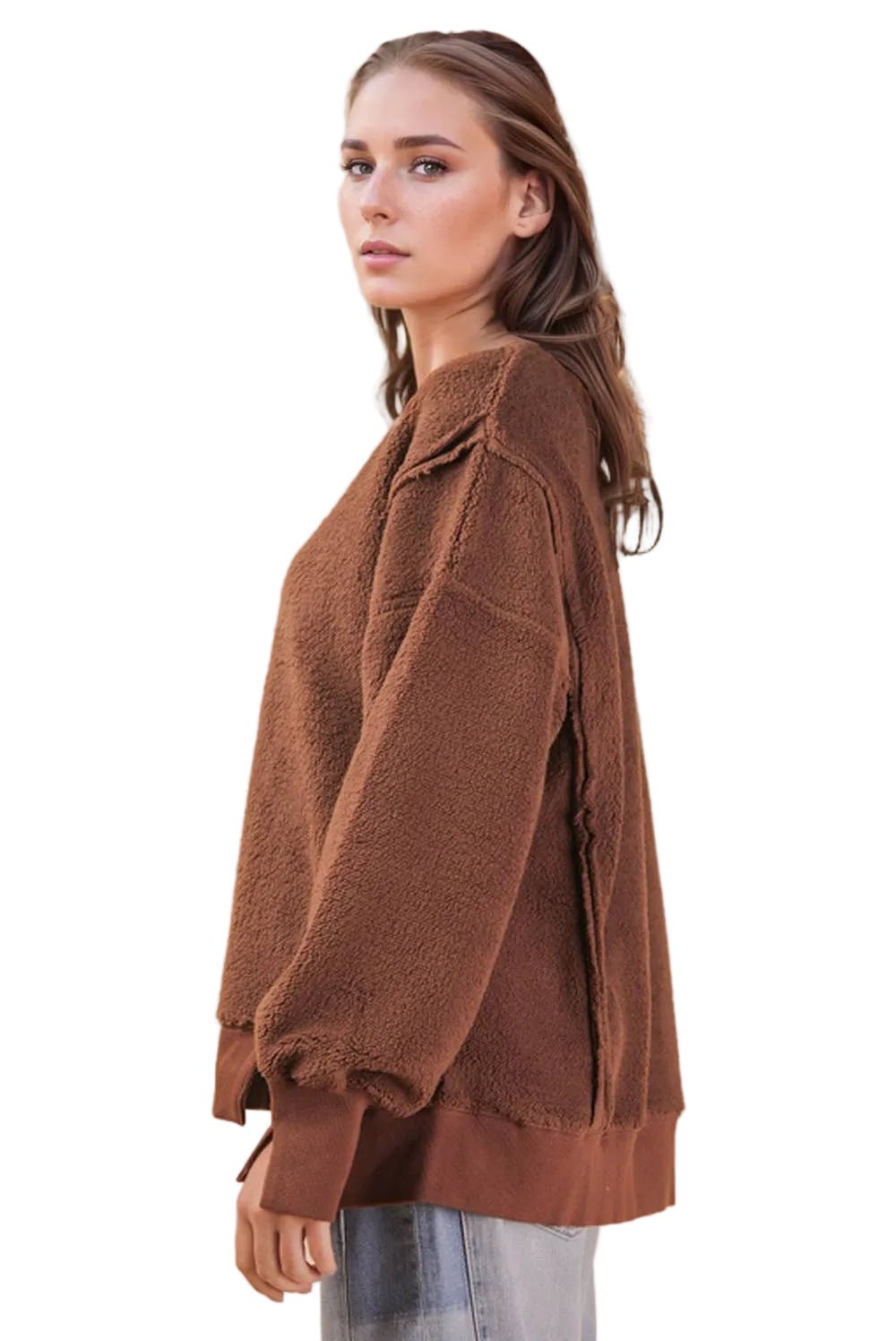 Side view of a chocolate brown oversized fleece pullover showing the relaxed fit, long sleeves and side slit hem