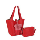 Red purse with red and white bow- mathcing red pouch against a white background.