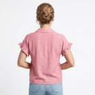 Person wearing a pink blouse and blue jeans on a white background
