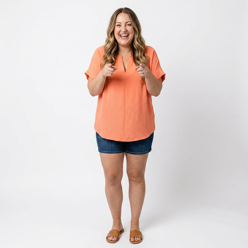 woman wearing a coral top and shorts against a white background