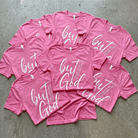 Pink t-shirts with 'but God' text on a gray surface