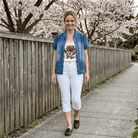 Puff sleeve denim top styled open over a floral shirt with white capris outdoors