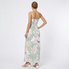 white background with woman showing the back of a floral dress