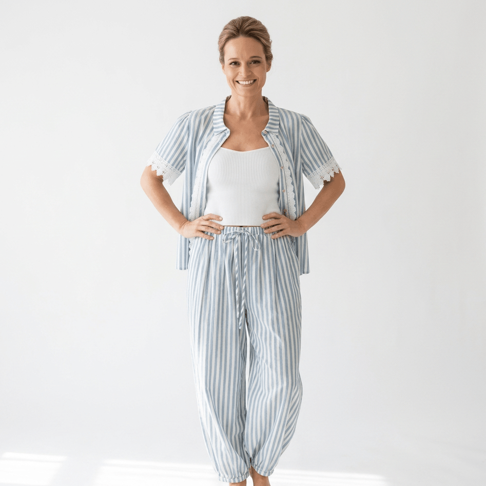 Woman wearing a striped pants set on a white background